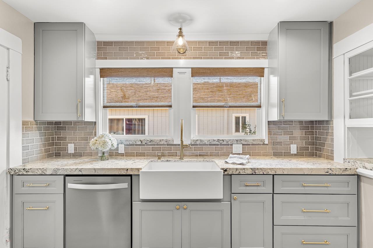 319 West 12th Street Tracy, CA 95376 - Photo 22 of 51 a kitchen with stainless steel appliances granite countertop a sink and a window