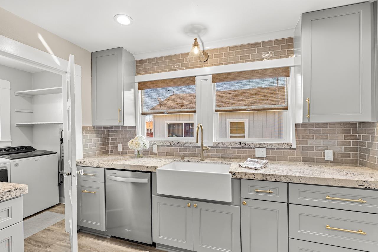 319 West 12th Street Tracy, CA 95376 - Photo 23 of 51 a kitchen with stainless steel appliances granite countertop a sink and a stove