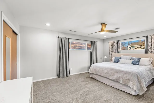 a bedroom with a large bed and a window