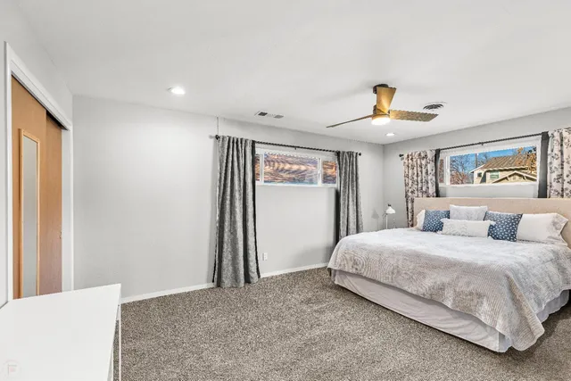 a bedroom with a large bed and a chandelier