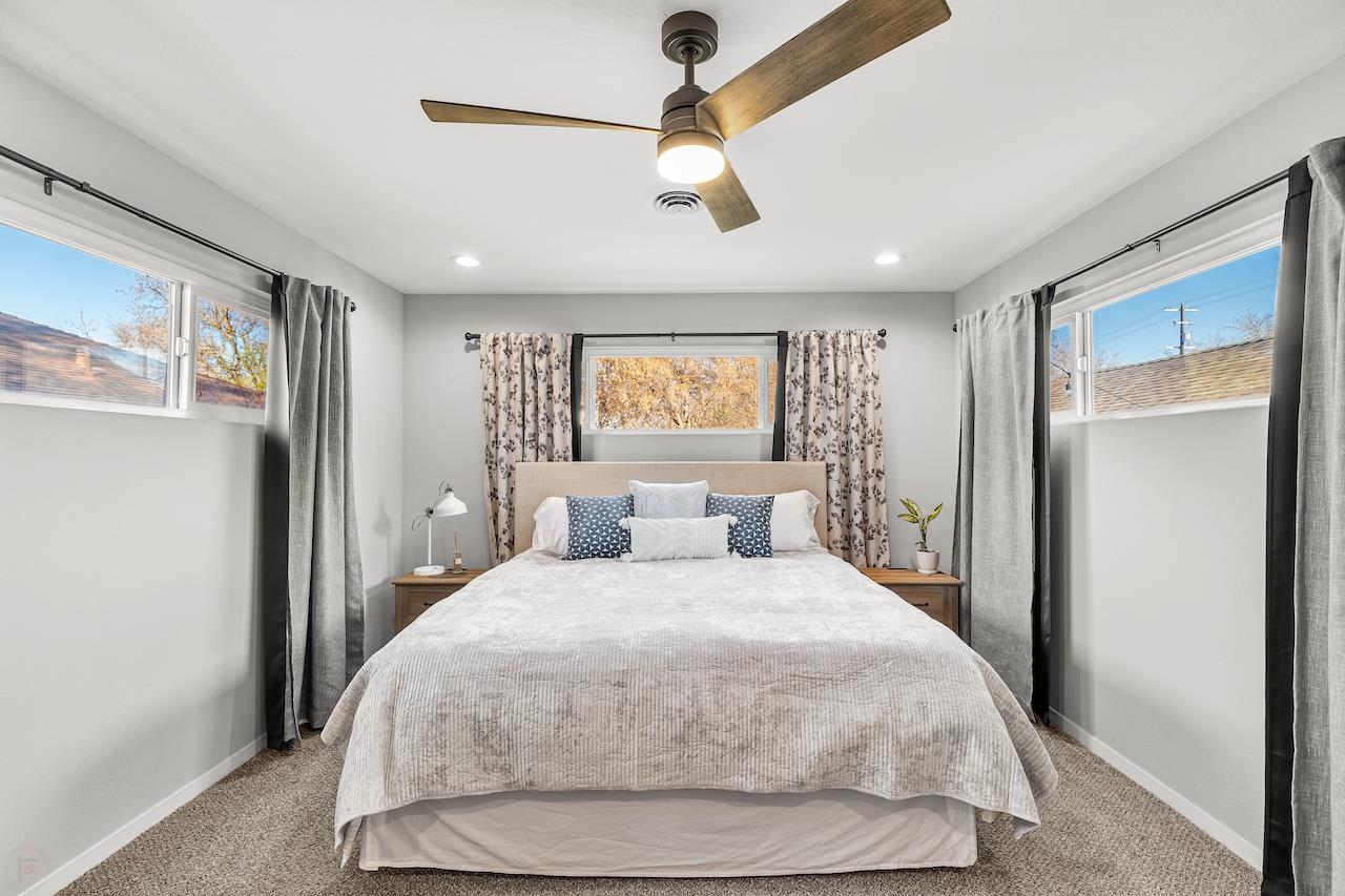 319 West 12th Street Tracy, CA 95376 - Photo 25 of 51 a bedroom with a large bed and a chandelier