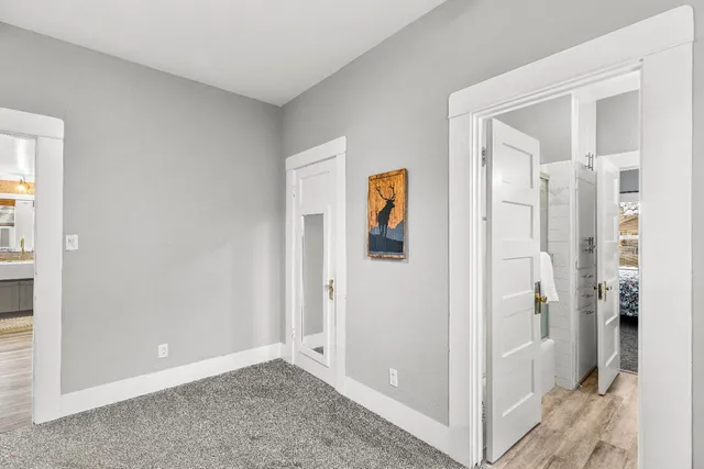 a large room with a couch and wooden floor