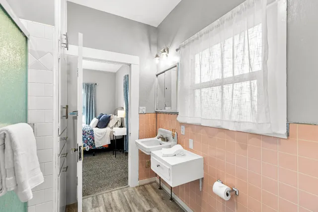 a bathroom with a sink a toilet and shower