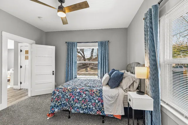 a bedroom with a large bed and a window