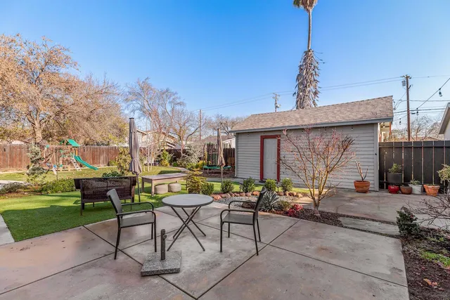 a backyard of a house with yard barbeque oven and outdoor seating