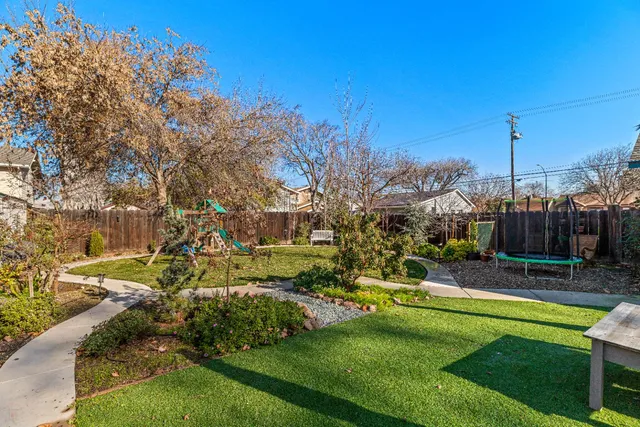 a view of a patio with table and chairs under an umbrella