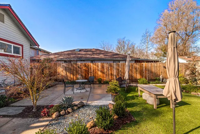 a view of a patio with table and chairs and potted plants