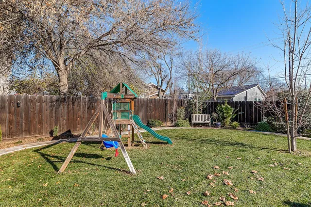 a front view of a house with swimming pool having outdoor seating