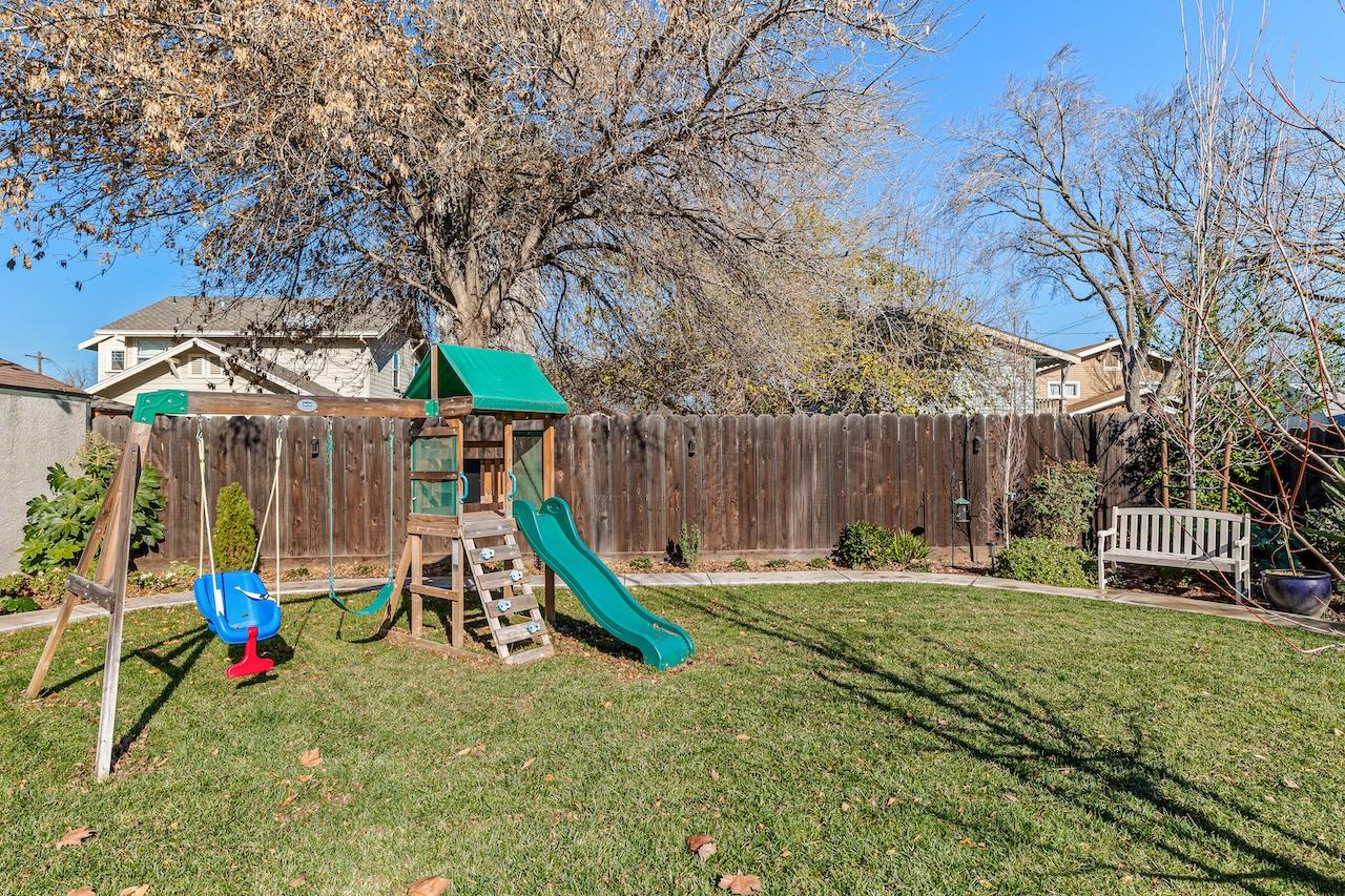 319 West 12th Street Tracy, CA 95376 - Photo 48 of 51 a view of a park with slide and a bench