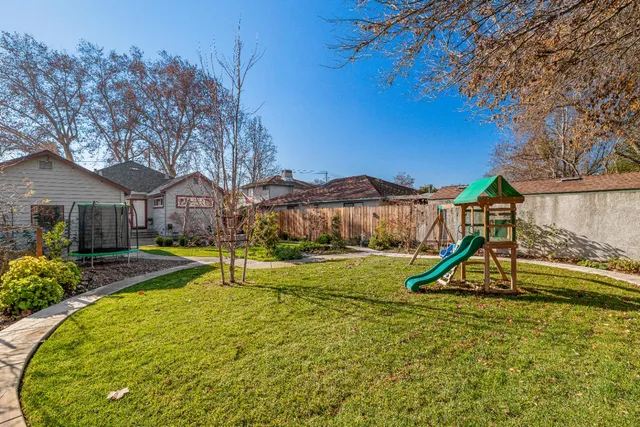 a front view of house with a garden and swimming pool