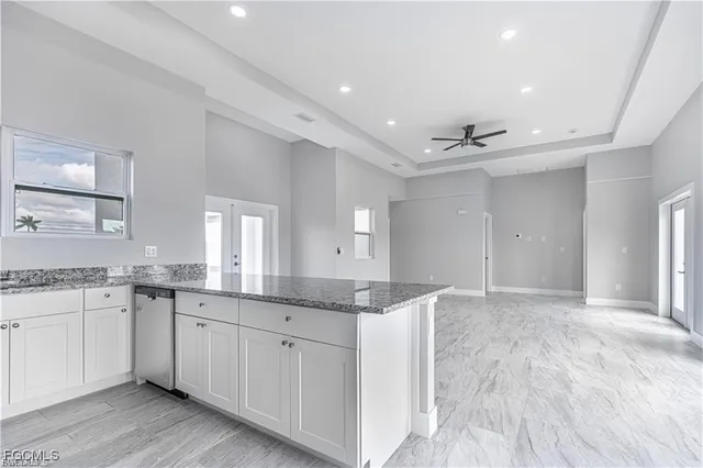 a bathroom with a granite countertop sink double vanity and a mirror