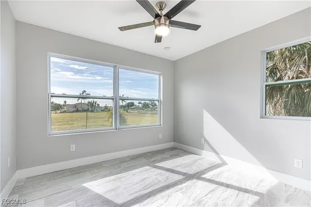a view of a bedroom with wooden floor and a window