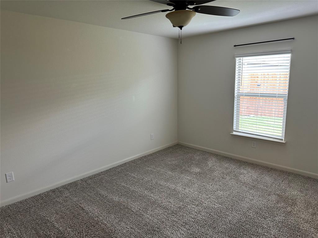 13624 Mineral Road Ponder, TX 76259 - Photo 15 of 26 Unfurnished room featuring a ceiling fan, carpet, and baseboards