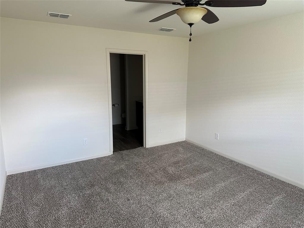13624 Mineral Road Ponder, TX 76259 - Photo 16 of 26 Carpeted empty room featuring ceiling fan and baseboards