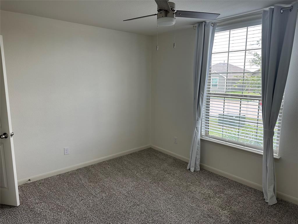 13624 Mineral Road Ponder, TX 76259 - Photo 4 of 26 Carpeted spare room with a ceiling fan, healthy amount of natural light, and baseboards