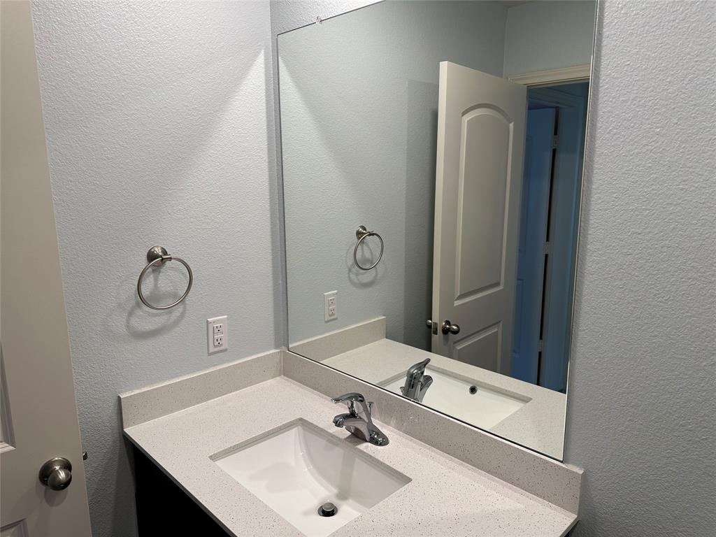 13624 Mineral Road Ponder, TX 76259 - Photo 5 of 26 Bathroom with a textured wall and vanity