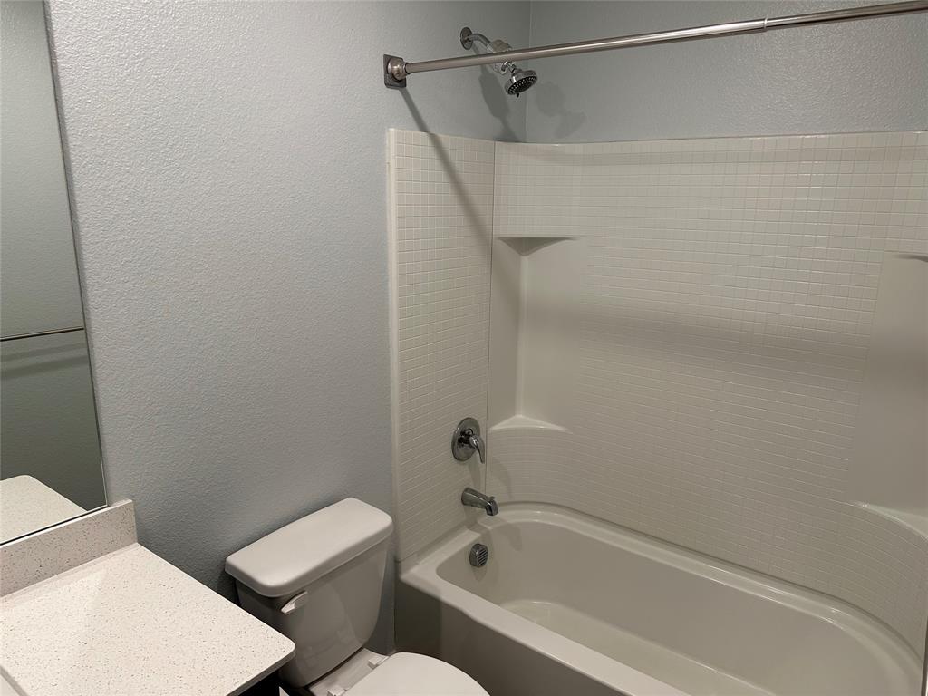 13624 Mineral Road Ponder, TX 76259 - Photo 6 of 26 Full bathroom featuring a textured wall, toilet, vanity, and shower / bath combination