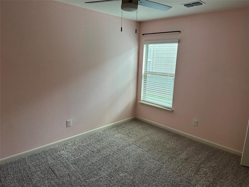 13624 Mineral Road Ponder, TX 76259 - Photo 8 of 26 Carpeted empty room with ceiling fan and baseboards