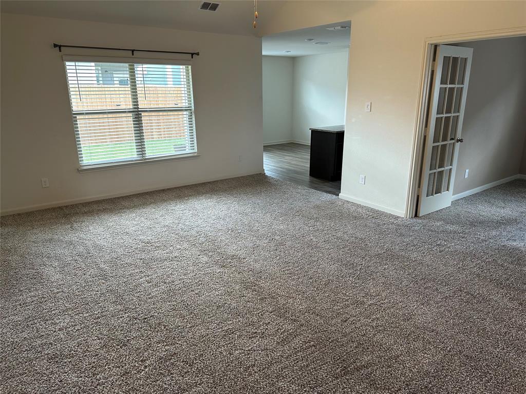 13624 Mineral Road Ponder, TX 76259 - Photo 10 of 26 Carpeted spare room featuring baseboards