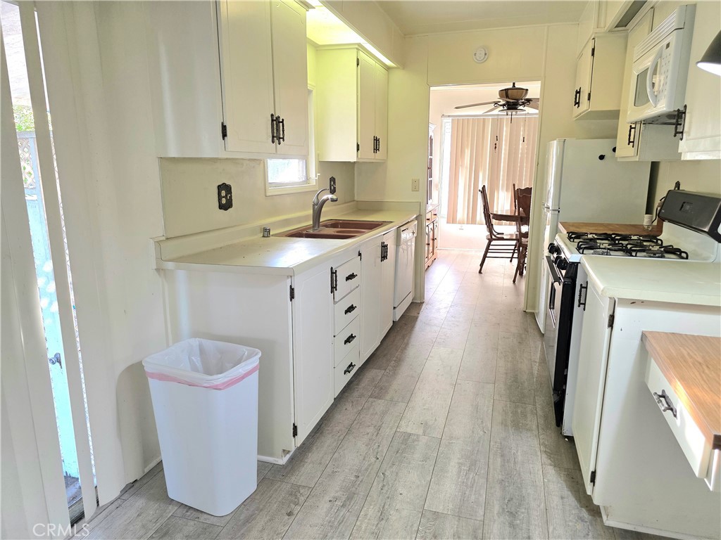 302 Sandpiper, Unit 283 Long Beach, CA 90803 - Photo 11 of 36 a kitchen with a sink a stove and cabinets