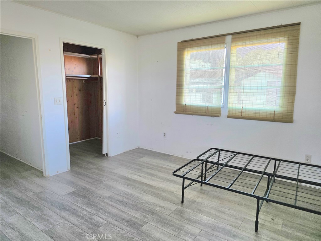 302 Sandpiper, Unit 283 Long Beach, CA 90803 - Photo 13 of 36 an empty room with wooden floor and windows