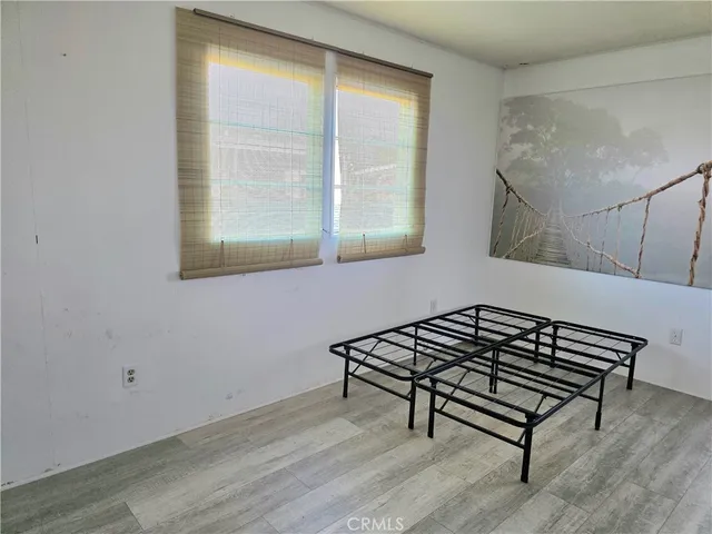 a view of a room with wooden floor and a window