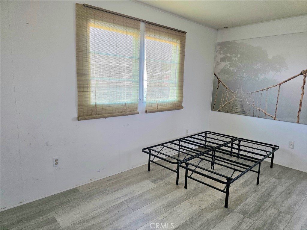 302 Sandpiper, Unit 283 Long Beach, CA 90803 - Photo 18 of 36 a view of a room with wooden floor and a window