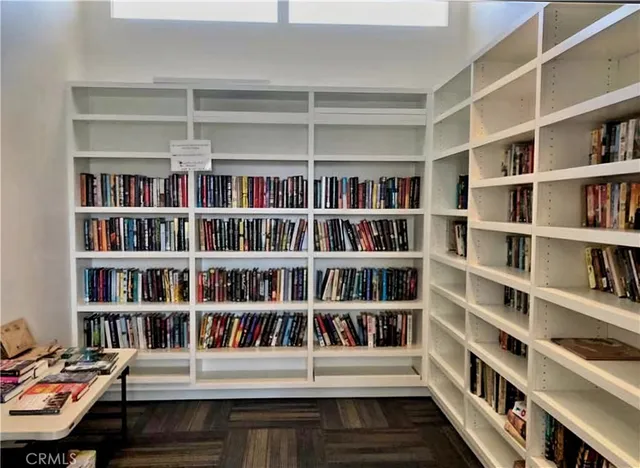 a living room with a book shelf and a book shelf