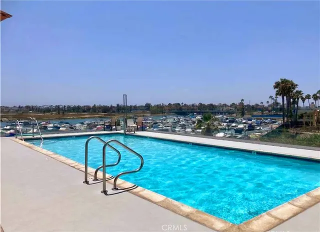 a view of swimming pool with outdoor seating and city view