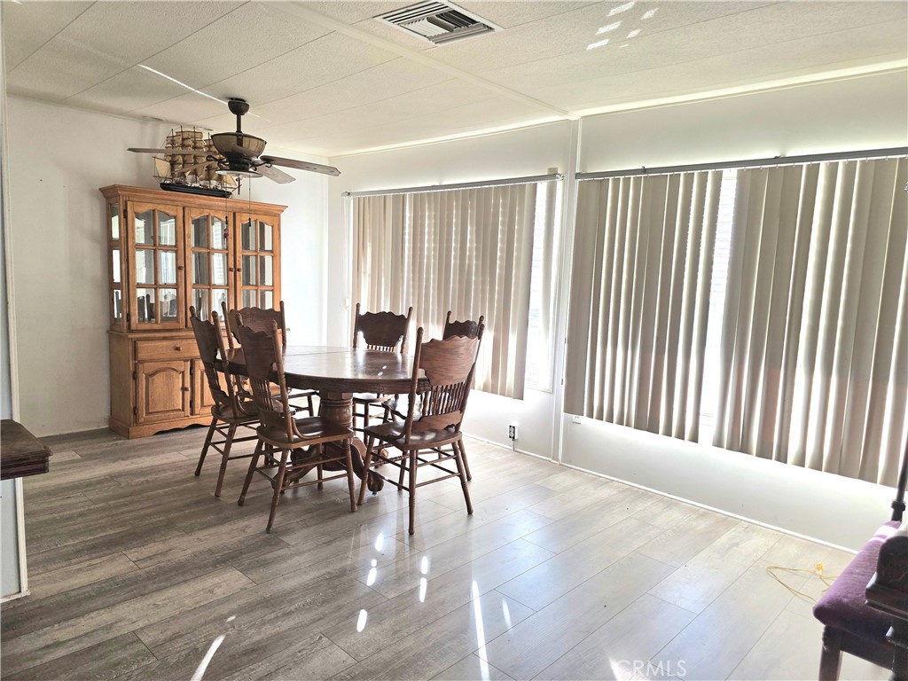 302 Sandpiper, Unit 283 Long Beach, CA 90803 - Photo 3 of 36 a view of a dining room with furniture window and wooden floor