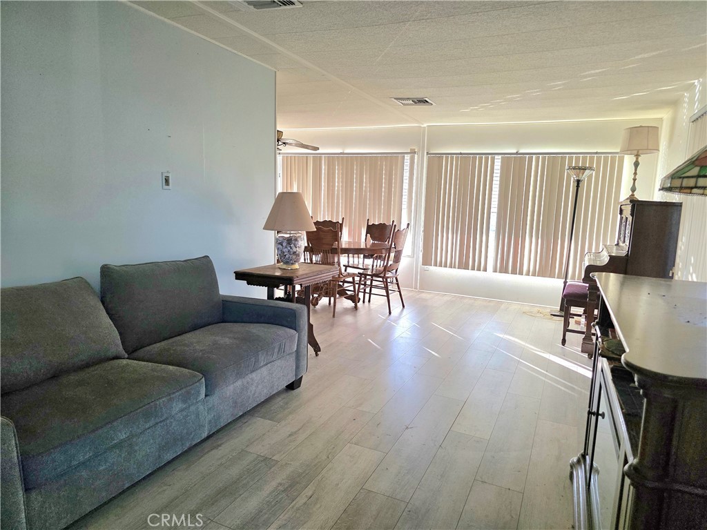 302 Sandpiper, Unit 283 Long Beach, CA 90803 - Photo 6 of 36 a living room with furniture and wooden floor