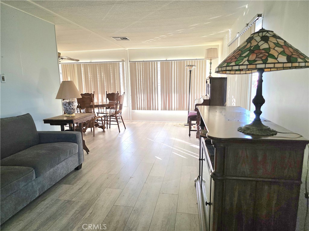 302 Sandpiper, Unit 283 Long Beach, CA 90803 - Photo 8 of 36 a living room with furniture and wooden floor