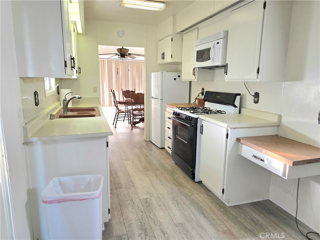 302 Sandpiper, Unit 283 Long Beach, CA 90803 - Photo 9 of 36 a kitchen with a stove a sink and a refrigerator