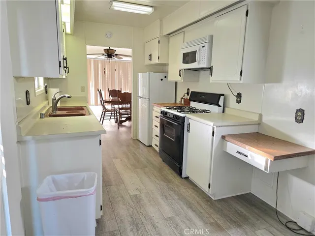 a kitchen with a stove a sink and a refrigerator