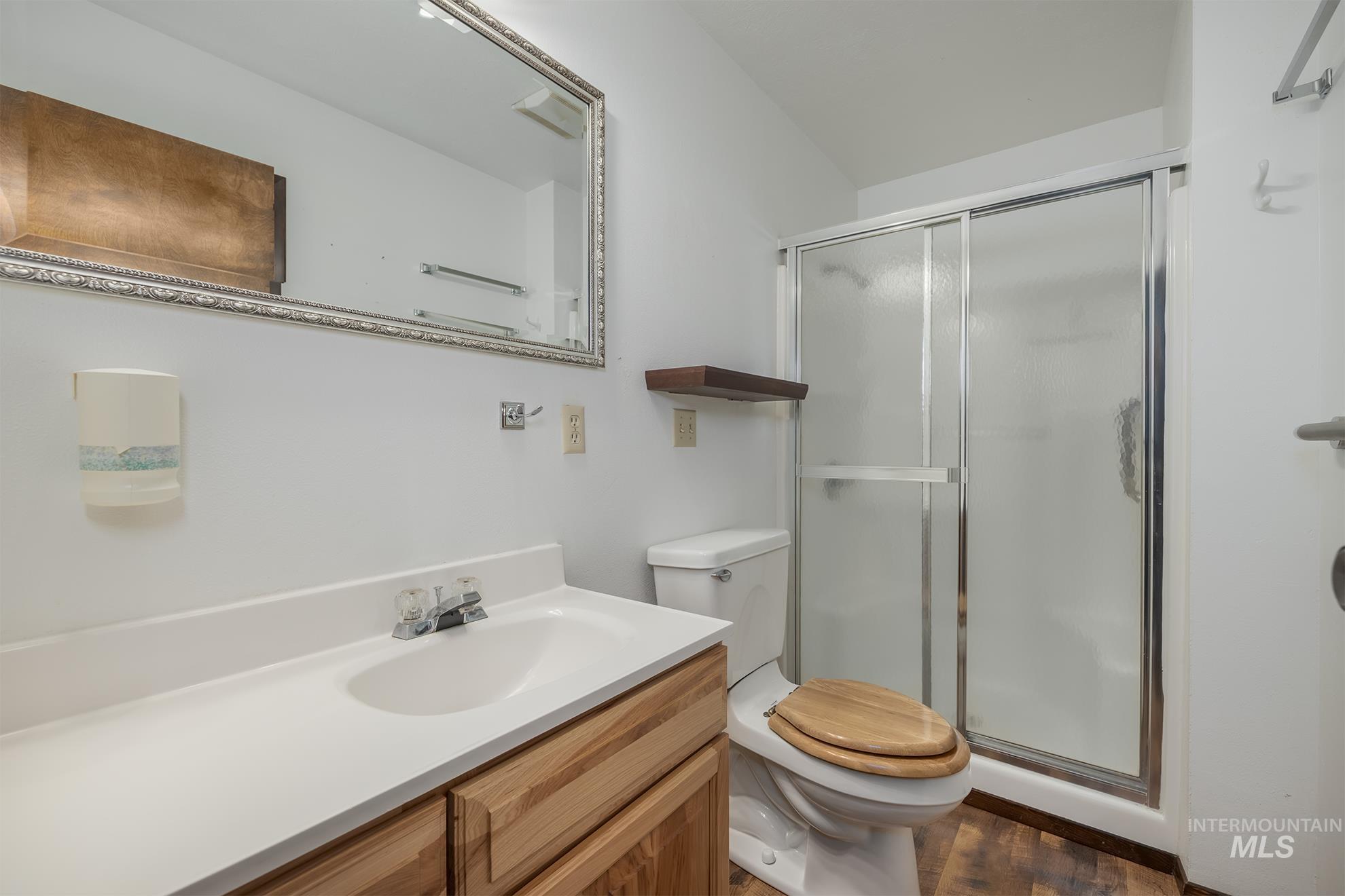 1493 Cove Road Weiser, ID 83672 - Photo 11 of 50 Bathroom featuring a single vanity with wood-finish cabinetry, a white countertop, and an integrated sink