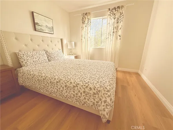 a large bed sitting in a bedroom next to a window