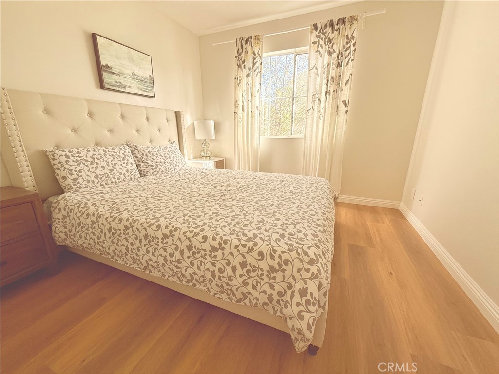 8 Marsala Irvine, CA 92606 - Photo 7 of 8 a large bed sitting in a bedroom next to a window