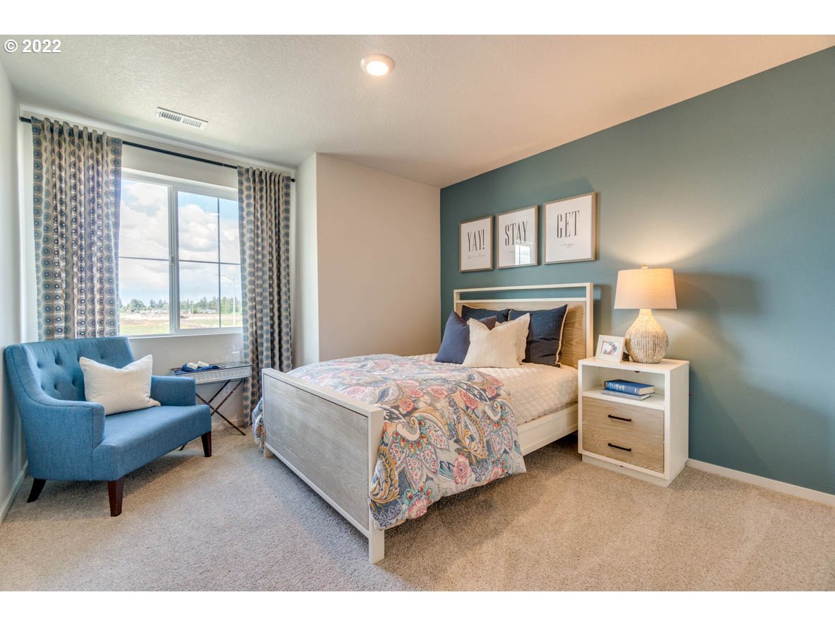 2978 Fenya Street Springfield, OR 97477 - Photo 13 of 20 a bedroom with a bed and a couch with exposed radiator