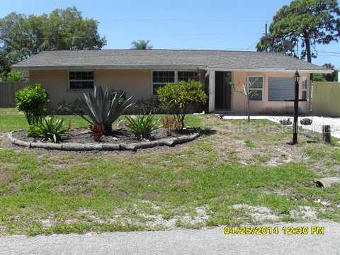 835 Seneca Road Venice, FL 34293 - Photo 1 of 1 a backyard of a house with plants and outdoor seating