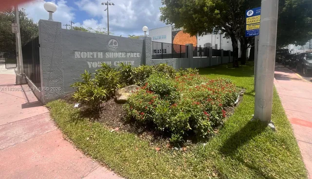 an aerial view of residential houses with outdoor space and swimming pool