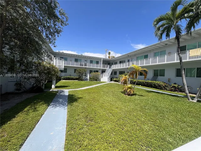 a view of a house with swimming pool and sitting area