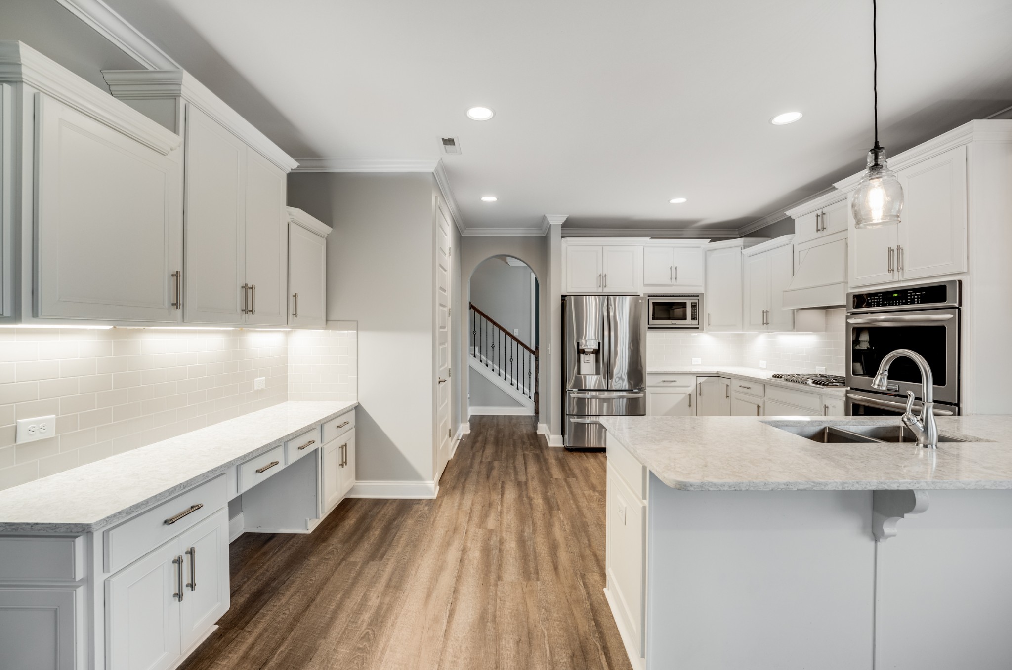 5001 Rizer Point Drive Franklin, TN 37069 - Photo 19 of 42 a kitchen with stainless steel appliances granite countertop a refrigerator oven a sink dishwasher and white cabinets with wooden floor