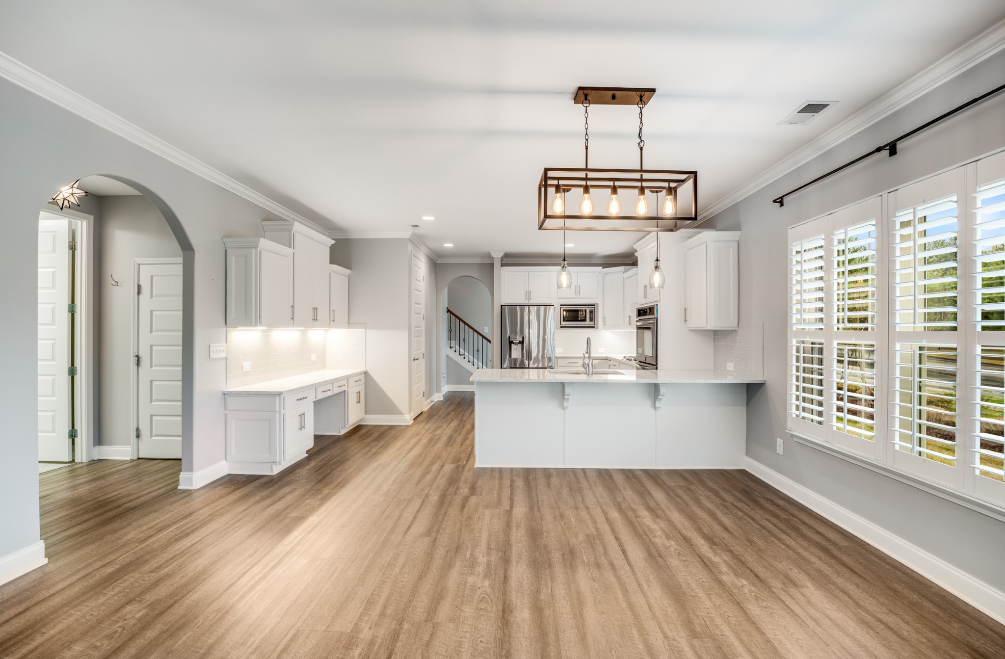 5001 Rizer Point Drive Franklin, TN 37069 - Photo 21 of 42 a view of a kitchen with kitchen island wooden floors center island and stainless steel appliances