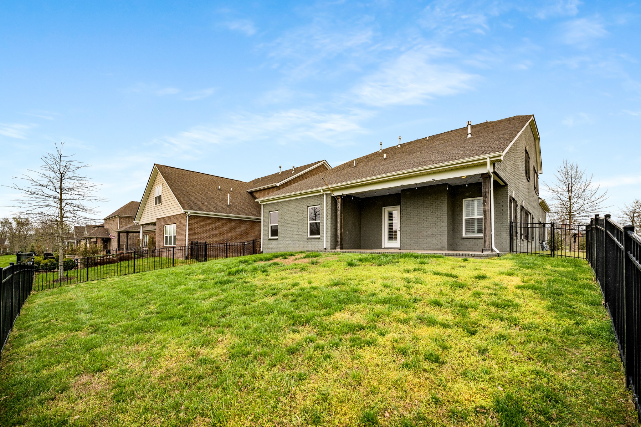 5001 Rizer Point Drive Franklin, TN 37069 - Photo 34 of 42 a yellow house with a big yard and large trees