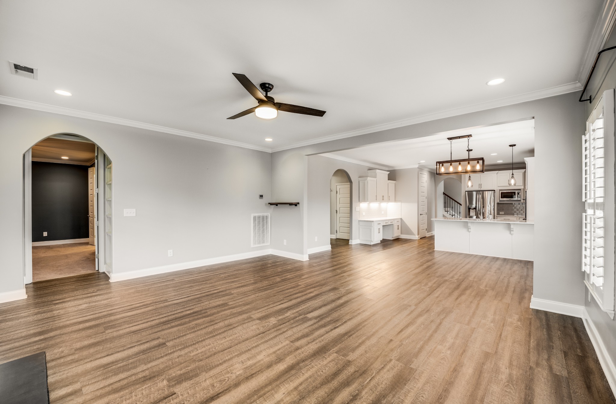 5001 Rizer Point Drive Franklin, TN 37069 - Photo 7 of 42 a view of a livingroom with wooden floor and a ceiling fan