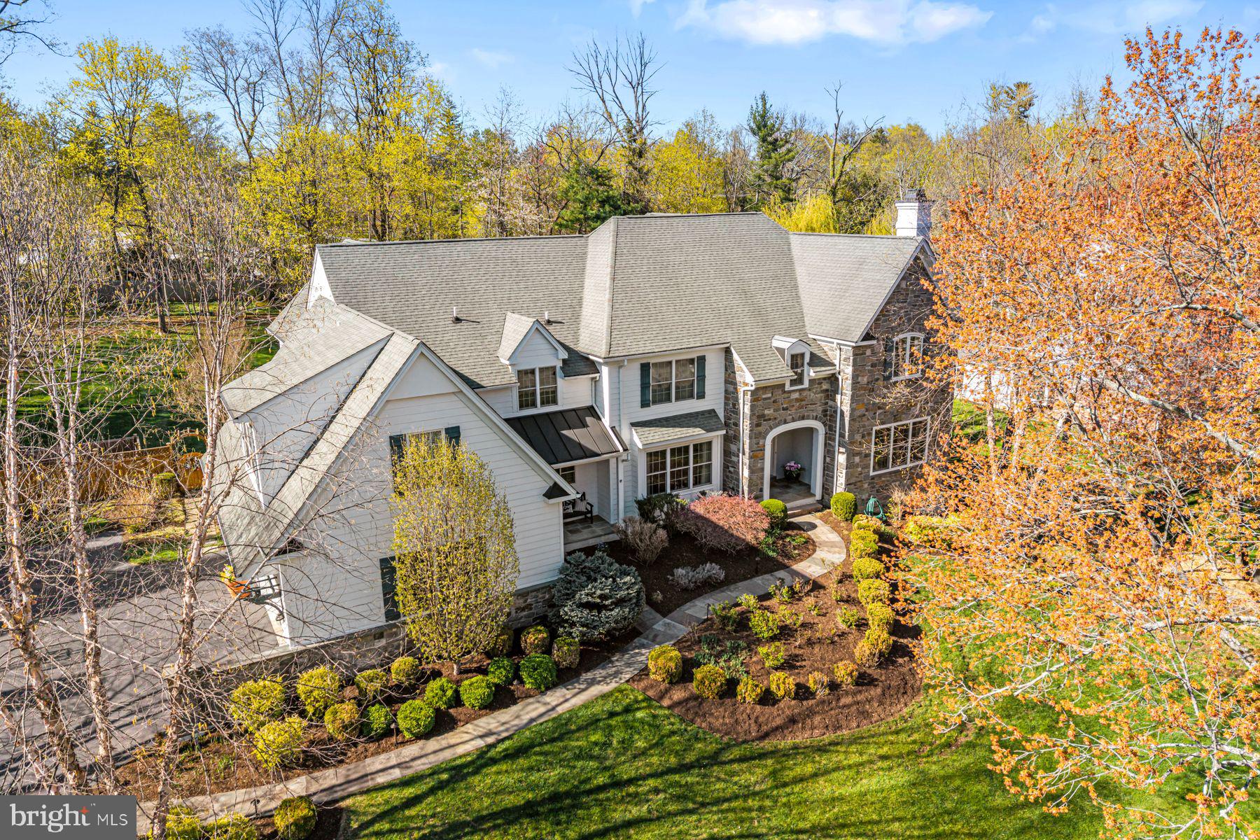 321 Exeter Road Devon, PA 19333 - Photo 11 of 79 an aerial view of a house with swimming pool and large trees