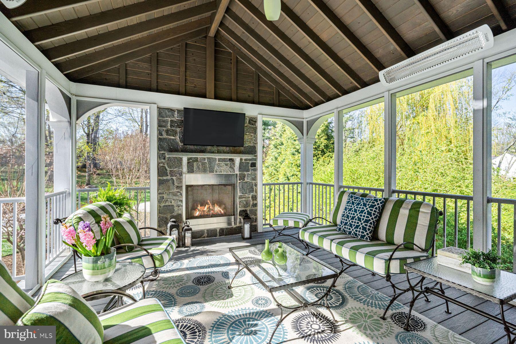 321 Exeter Road Devon, PA 19333 - Photo 31 of 79 a living room with patio furniture and a floor to ceiling window next to a yard