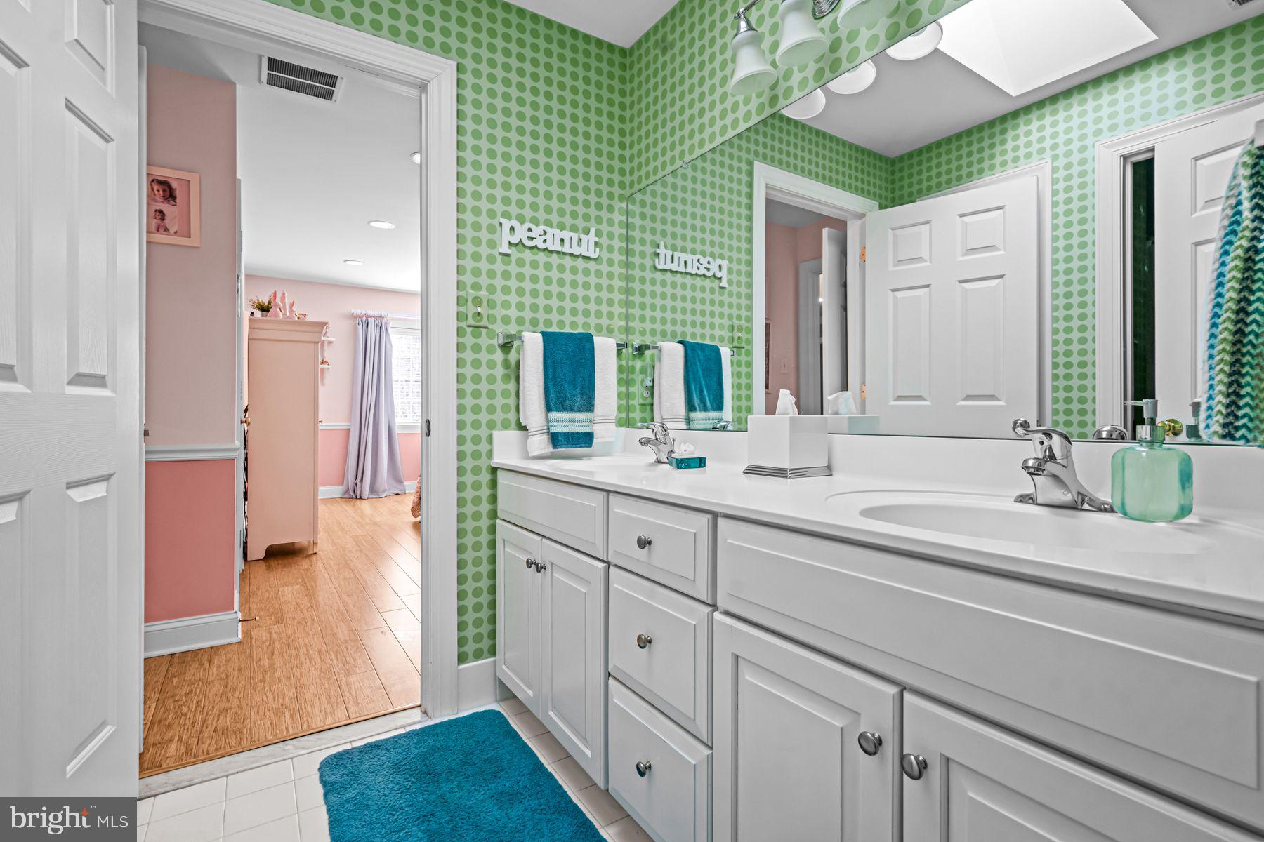 321 Exeter Road Devon, PA 19333 - Photo 56 of 79 a spacious bathroom with a double vanity sink mirror and next to a window