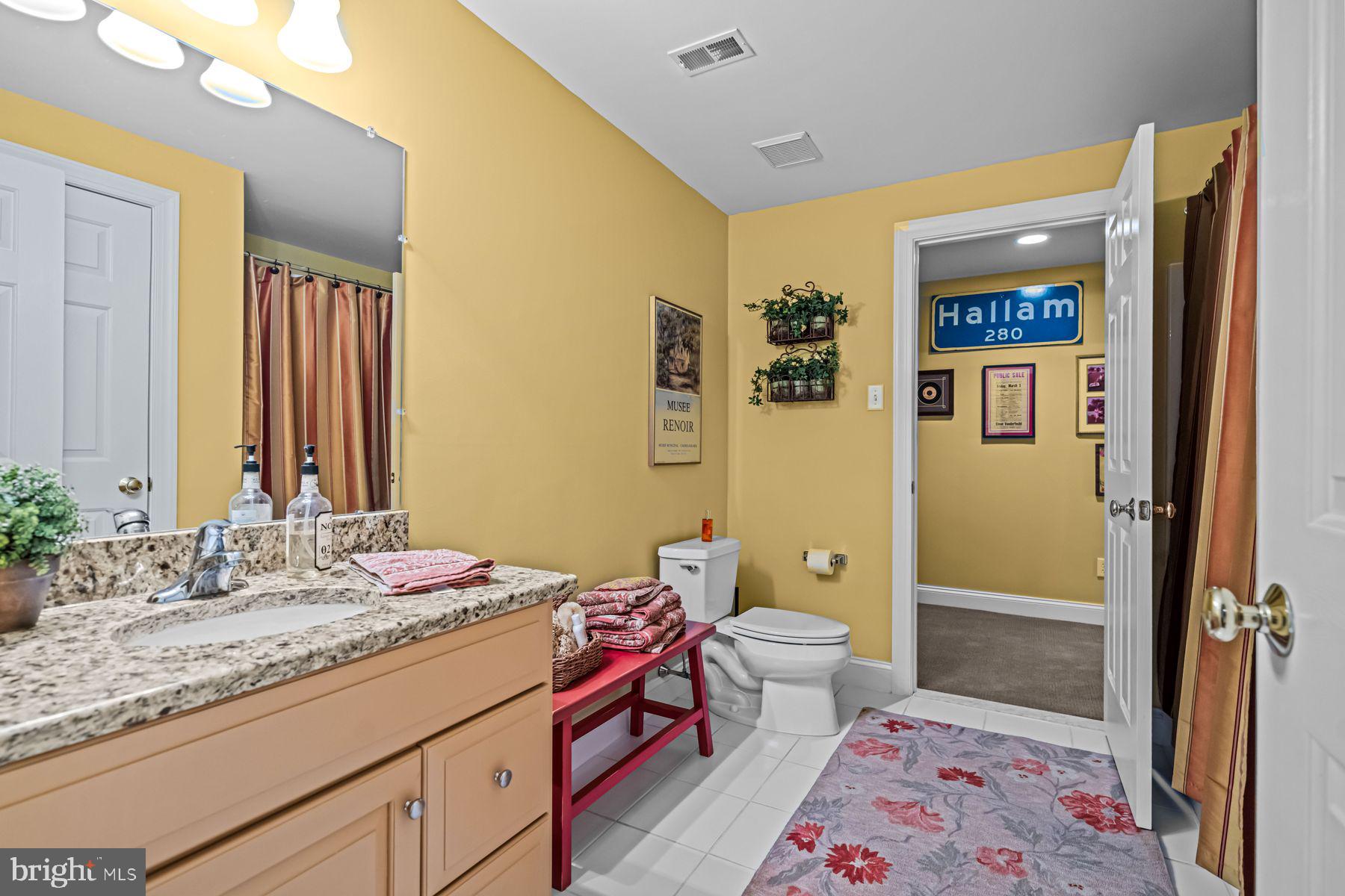 321 Exeter Road Devon, PA 19333 - Photo 67 of 79 a spacious bathroom with a granite countertop sink and a mirror