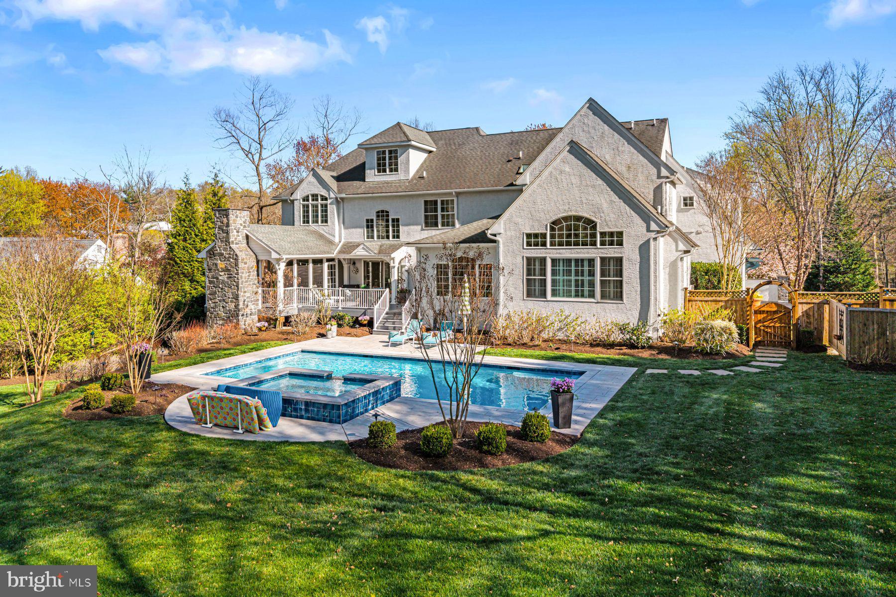 321 Exeter Road Devon, PA 19333 - Photo 73 of 79 a front view of house with a garden and swimming pool